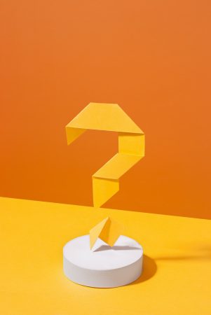 Artistic yellow and orange background with origami question mark